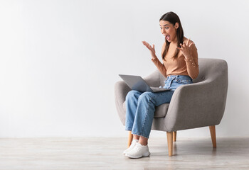 Poster - Lottery win, good luck, success, amazing online sale. Emotional young woman sitting in armchair with laptop, looking at screen, shouting in excitement, winning huge casino bet, copy space