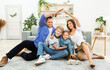 © Prostock-studio - Family Housing Concept. Parents Making Symbolic Roof Joining Hands Above Their Kids Sitting On Floor At Home.
