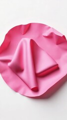 Leinwandbilder - A pink paper plate sits atop a clean white table, perfect for serving snacks or displaying decorative items