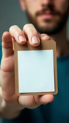 Aufkleber - A person holding a document or note