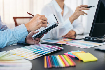 Poster - Team of creative graphic designer working on color swatch samples chart for selection coloring in inspiration to create new collection at workplace