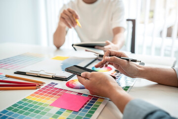 Poster - Team of creative graphic designer working on color swatch samples chart for selection coloring in inspiration to create new collection at workplace