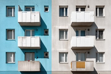 Poster - A blue and gray building facade featuring several balconies and windows, creating a geometric and architectural contrast, with a touch of minimalist design.