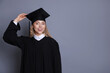 © New Africa - Happy student after graduation on grey background. Space for text