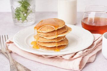 Wall Mural - Plate of tasty pancakes with maple syrup on white background