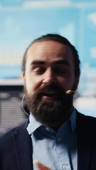 Poster - Vertical Video Professional businessman delivers inspiring business pitch on stage, using a hands free microphone. Visionary CEO and motivational speaker addresses attendees with charts and data