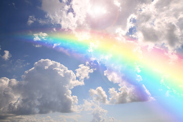 Wall Mural - bright rainbow in blue sky with clouds on sunny day