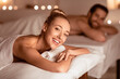 © Prostock-studio - Happy Lady And Her Husband Relaxing At Luxury Spa Enjoying Aromatherapy Lying On Beds And Smiling To Camera. Relaxation And Wellness, Beauty Treatment For Two. Selective Focus
