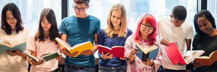 Poster - Diverse group of young adults reading books together. Students enjoying reading. Multicultural group of friends with books. Learning and reading in a group. Diverse teenagers reading books at library.