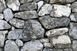 © andy0man - stack of large rough natural grey stone wall texture for background