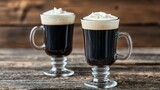 Two irish coffees on a wooden surface.