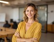 © AndyAziz - Smiling woman stands in an office setting