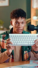 Poster - Keyboard, live streaming and promotion with man in studio for gaming pad, ergonomic and influencer. Product feedback, tech guide and content creator with person in home for recording and review