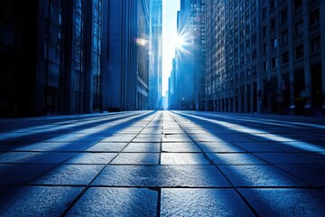 Poster - Sunlit city street between towering skyscrapers, creating a dramatic and serene cityscape.