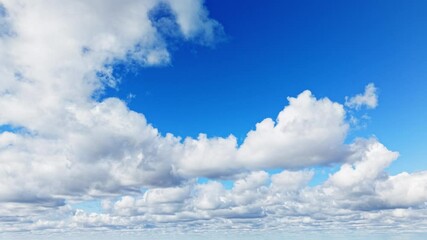 Wall Mural - Timelapse of fluffy white clouds moving across a bright blue daytime sky