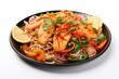 © Hafsa - Fresh salmon noodles with colorful vegetables and lime slices prepared on a black plate