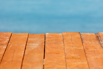 Wall Mural - A wooden board with a blue sky in the background