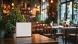 © Turab - Blank frame on wooden table with plants in restaurant setting and blurred background filled with lights