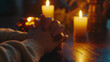 © sticker2you - Calm hands clasped together in prayer near glowing candles, creating serene atmosphere