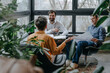 © Westend61 - Happy businessman having discussion with colleagues in office