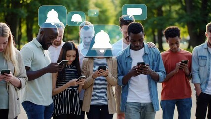 Poster - Young diverse group standing together in urban park, heads lowered, communicating through digital devices with floating chat bubble graphics representing social media interaction