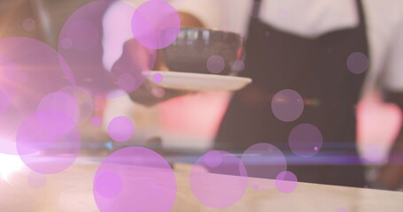  - Image of purple dots over barista making coffee