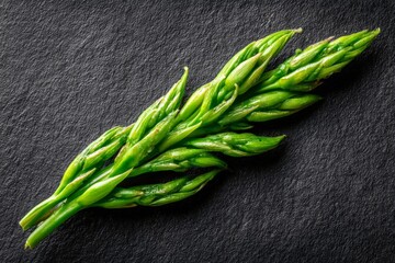 Aufkleber - Freshly harvested asparagus stalks displayed on a dark stone surface showcasing their vibrant green color and texture
