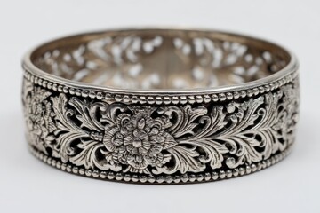 Poster - Ornate silver bangle featuring intricate floral design displayed against a plain background