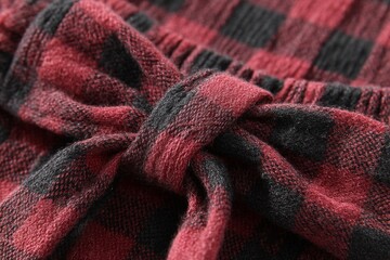 Poster - Checkered fabric featuring a bow in dark red and black patterns at a close distance
