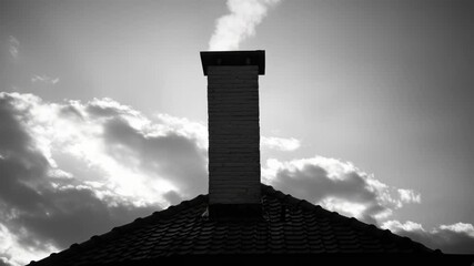 Aufkleber - A simple black and white photograph of a chimney on a roof