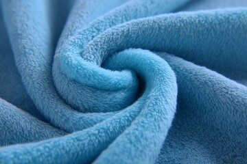 Poster - Soft blue fabric in a gentle swirl showcasing texture and color in natural light
