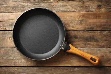 Aufkleber - Suitable frying pan rests on a rustic wooden surface ready for cooking meals and baking delights