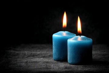 Aufkleber - Blue candles emit warm light in a dark setting, creating a tranquil atmosphere for relaxation and meditation