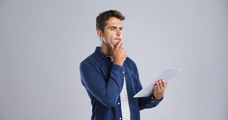 Leinwandbilder - Search, tablet and man with thinking in studio for app decision, game download and planning. Mockup, confused user and digital tech on white background for website update, connection fail or solution