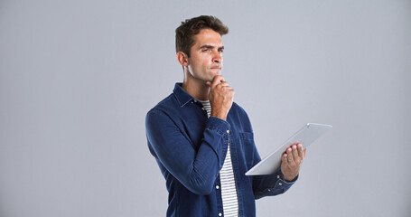 Leinwandbilder - Journalism, tablet and thinking with editor man in studio for proofreading article of online magazine. App, ideas and post editing with freelance journalist on white background space for publishing