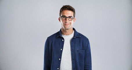 Poster - Man, portrait and glasses for fashion or vision, trendy eyewear and stylish in studio. Designer frame, spectacles and male person with denim style, space and prescription lens on white background