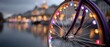 © yuce - Illuminated bicycle wheel by a dreamy city
