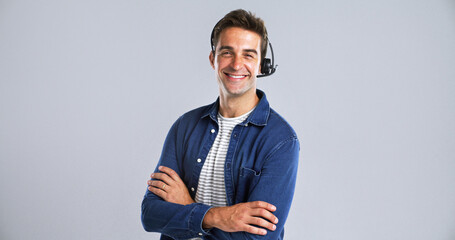 Fototapete - Happy man, portrait or consultant with headset or confidence in studio on a white background. Male person, agent or tech with smile or arms crossed for online customer service or CRM on mockup space