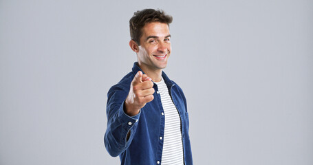 Poster - Portrait, pointing to you and man with smile, choice and confidence on white studio background. Face, happy person or model with gesture, opportunity or decision with sign up, motivation or selection