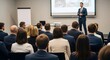 © ipika - A poised presenter captivates an audience with a professional lecture in a modern auditorium, creating an atmosphere of learning and engagement.
