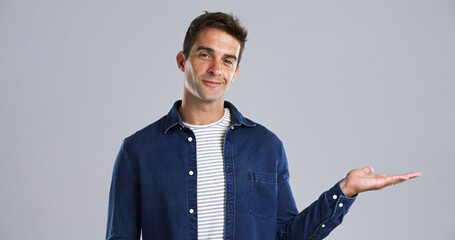 Poster - Happy man, portrait and hand out with advertising in studio for marketing on white background. Male person, model or smile with palm or deal for notification, alert or promotion on mockup space
