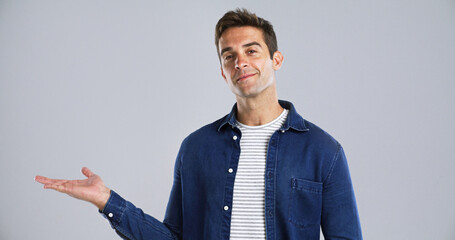 Poster - Man, portrait and hand out with advertising in studio for marketing on white background. Male person, model or smile with palm or deal for notification, alert or fashion promotion on mockup space