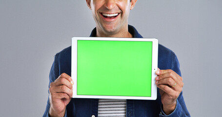 Fototapete - Tablet, man and green screen with mockup in studio, UI advertising or website ads for blog. Hands with display space, technology or marketing for streaming subscription with promo on white background