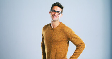 Fototapete - Glasses, portrait and smile of tech guru in studio for computer engineering or development. IT support, small business and technician or happy programmer man on white background as script coder