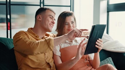 Poster - Couple, laughing or pointing to tablet on sofa for online shopping, app choice or web browsing. Relax, people and bonding together with digital tech in home for purchase decision or streaming service