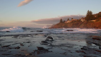 Wall Mural - Beautiful morning view of wave crashing into the rocky platform