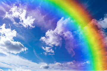 Wall Mural - bright rainbow in blue sky with clouds on sunny day