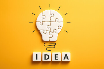 Poster - A concept innovation and creativity formed by interconnected puzzle pieces shaped like a light bulb symbolizes the process generating new ideas in business