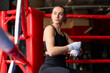 © New Africa - Woman wrapping her hands on boxing ring