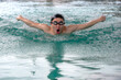 © Jack Tamrong - Front view Asian male swimmer swimming butterfly stroke in pool